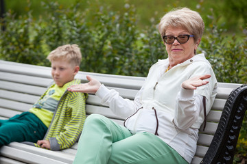 Grandmother gives her hands after unpleasant conversation to her grandson