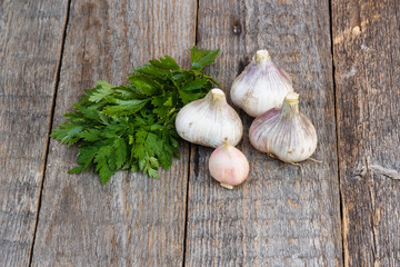 Garlic and herbs on wooden background. Proper nutrition, good healthy food. Copy space