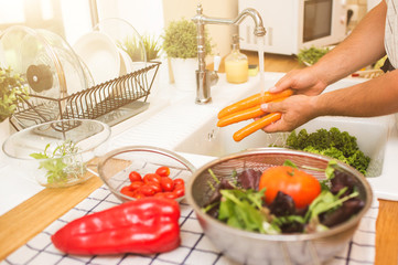Man washes vegetables before eating