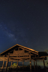 Starry night with milky way and blue sky and wooden Pavilion