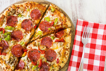 Pepperoni Pizza With Fork on Checkered Napkin