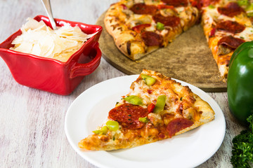 Pepperoni Pizza Slice With Parmesan Cheese and Green Pepper