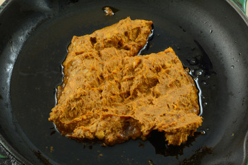 Raw chorizo pork sausage in cast iron frying pan skillet coated lightly with olive oil