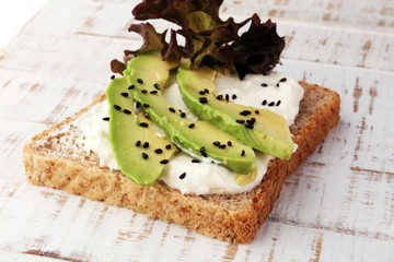 Sandwich with avocado and sesame - healthy breakfast concept