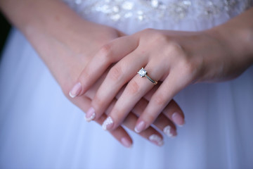 Bride's hands, showing proudly the wedding or engagement ring. Wedding concepts, details, ideas and themes, bride morning preparation.