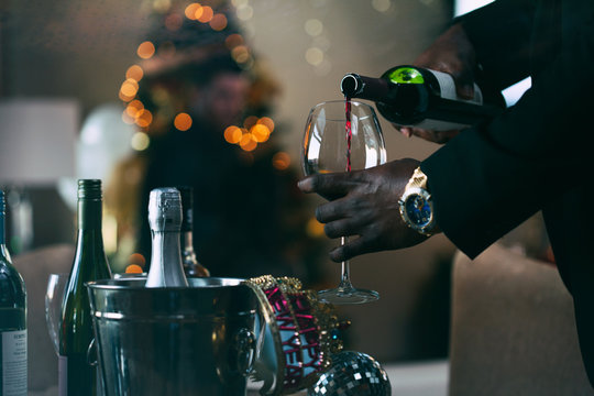 NYE: Man Pouring Glass Of Wine At Christmas Holiday Party