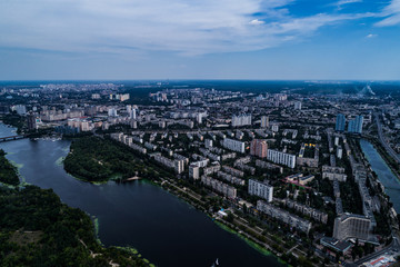 Fototapeta na wymiar Panoramic view of the city of Kiev with the Dnieper River on the left bank. Aerial view of the residential district of Rusanivka and the metro station Levoberezhnaya