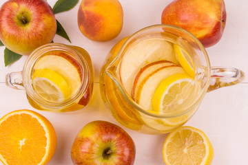 pitcher and a mug with a cool fruit drink on a wooden table. Top view