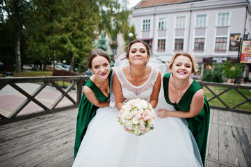 Fabulous bride walking, posing and having fun with her bridesmaids in the downtown on a wedding day.