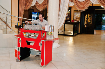 Skillful bartender performing bar tricks in front of a big audience on the wedding.