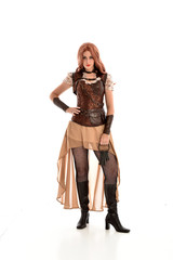 full length portrait of a red haired lady, wearing a steampunk inspired outfit, isolated  on white background.