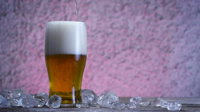 Beer, ice on wooden table
