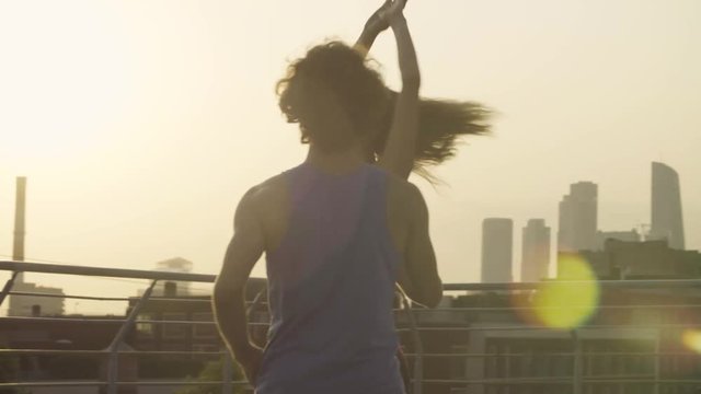 Silhouettes of young couple dancing on sunset