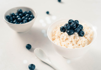 Cottage cheese with blueberries on wood