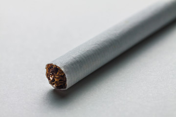 Close-up of a cigarette on a blank surface