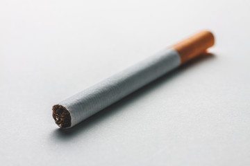 Close-up of a cigarette on a blank surface