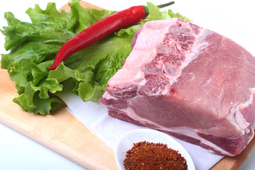 Raw pork chops with herbs and spices on cutting board. Ready for cooking.