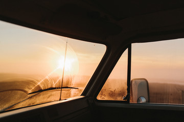 orange sunset through windshield of van