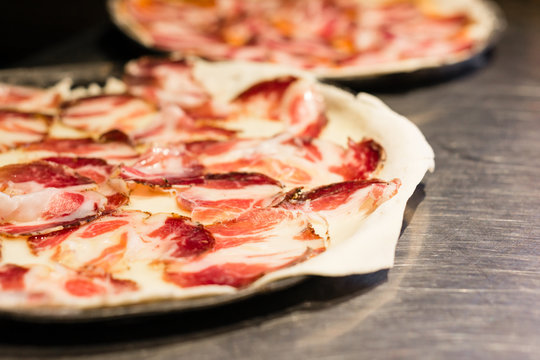 Simple traditional pizza with capocollo Italian salami