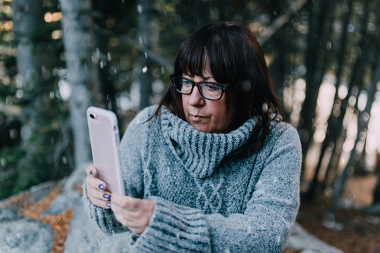 A woman in her fifties standing in the snow