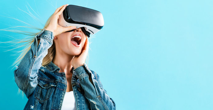Happy young woman using a virtual reality headset