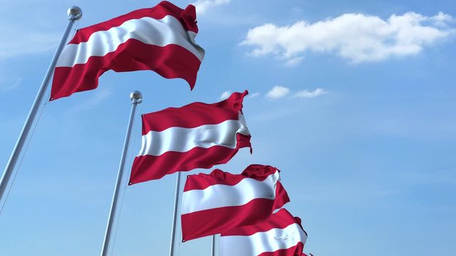 Row of waving flags of Austria agaist blue sky, seamless loop