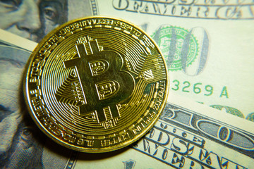 Golden bitcoin coin on the one hundred dollars banknote. Macro. Cryptocurrency concept