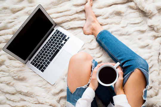 Overhead view, woman in bed with Coffee and Computer