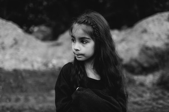 Thoughtful little girl in a black sweater