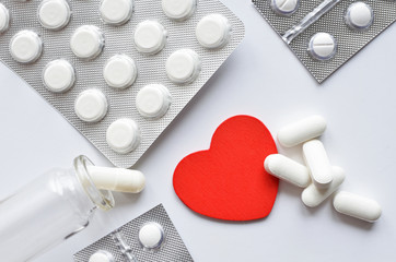 red heart with packings of pills