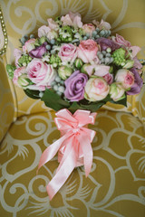 Pink, purple and green bridal bouquet on the chair