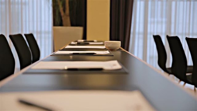 Conference room table with pen and notepads with no people