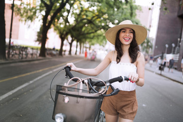 Portrait of beautiful young woman enjoying time on bicycle