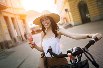 Portrait of beautiful young woman enjoying time on bicycle