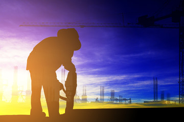 Fototapeta premium Double exposure of silhouette construction worker