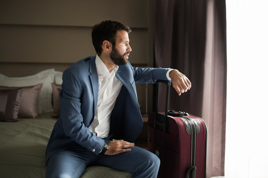Portrait of successful businessman siiting in hotel room