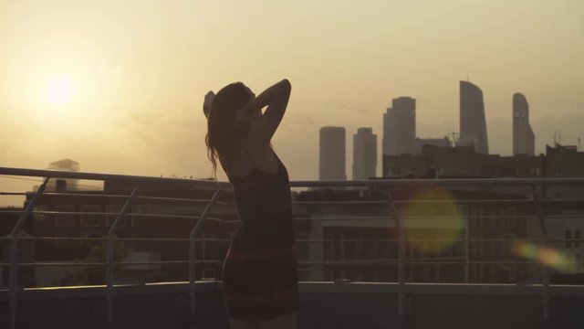 Silhouettes of young couple dancing on sunset
