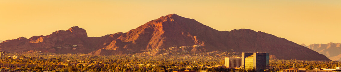 skyline of downtown Phoenix Arizona shot from Sky Harbor Airport with the famous Camelback Mountain at sunset