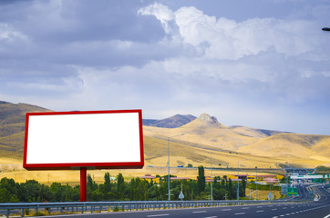 Blank white billboard on the background of the highway