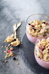 Two glasses of fruit yoghurt with granola