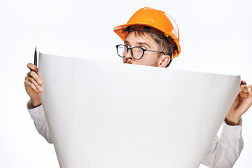 Engineer man with a beard on a white isolated background holds a drawing