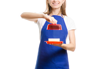 Beautiful girl in apron with butter dish