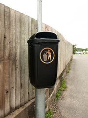 Obraz premium a public black bin on metal post isolated