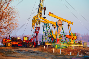 The oil derrick of oil field sunset