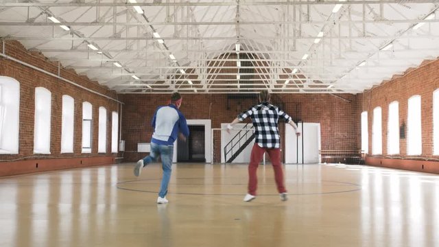 Two Breakdancers Moving In Sync. Slow Motion