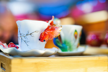 White porcelain cup with golden fish