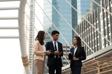Asian business team discussing outdoor work
