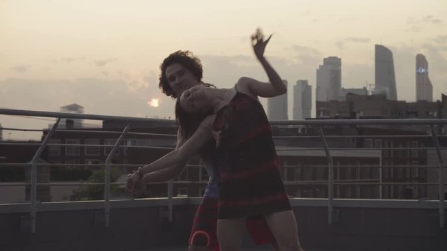 Young couple dancing on sunset