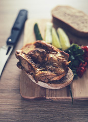 Close up still life bread meat and vegetables on tthe board and wwooden table in rustic style