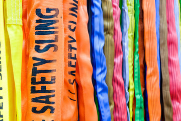 Multicolored of safety sling, Sling for industrial use during safety on industrial factory, construction and logistics, selective focus at safety sling word